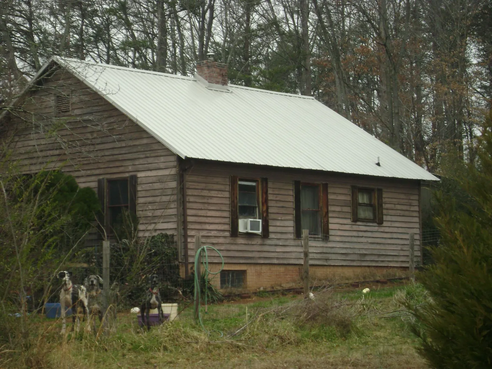White metal roof on an old wood sided farmhouse, from a Metal Roof Installation job in Ijamsville